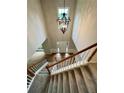 Bright foyer showcasing a staircase, wood floors, and a stylish chandelier at 655 Wellingborough Ct, Alpharetta, GA 30005
