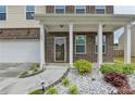 Inviting front porch with brick detailing and landscaped garden, creating a warm welcome to the home at 1603 Maston Rd, Auburn, GA 30011
