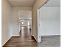 Hallway with hardwood floors leading into a spacious kitchen, creating a seamless flow between rooms at 1603 Maston Rd, Auburn, GA 30011