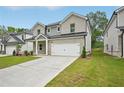 Modern home with a gray brick exterior, spacious driveway, and an attached two-car garage, freshly manicured lawn at 3970 Brushy St, Powder Springs, GA 30127