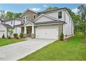 Charming two-story home boasts stone accents, a two-car garage, and a lush lawn at 3974 Brushy St, Powder Springs, GA 30127