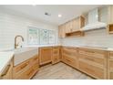 Well-lit kitchen showcases custom wood cabinets, stainless steel appliances, a farmhouse sink, and modern white countertops at 1349 Mckinsey Rdg, Loganville, GA 30052