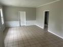 Living room with tile floors, textured half wall, neutral colors, and doorway to another room at 2076 Garden Cir, Decatur, GA 30032