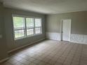 Living room with tile floors, textured half wall, neutral colors, and natural light from three windows at 2076 Garden Cir, Decatur, GA 30032