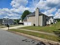 A well-maintained home featuring an attached two-car garage and a neat, grassy backyard at 4279 Persian Ct, Snellville, GA 30039
