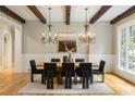 This dining room has wood floors, wooden beams on the ceiling, and large windows with natural lighting at 939 Middle Fork Trl, Suwanee, GA 30024