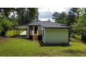 Rear view of the house, featuring a wood deck and the house's carport at 1931 Selwyn Dr, Decatur, GA 30035