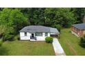 Aerial view of a freshly painted single-story home with lush green lawn and mature trees at 1931 Selwyn Dr, Decatur, GA 30035