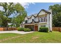 Charming two-story home with a second story balcony, covered porch, manicured lawn, and wood accents at 2721 Old Concord Se Rd, Smyrna, GA 30082