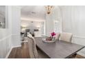 Formal dining area with hardwood floors, chandelier, and view to the living room at 5245 Chemin De Vie, Atlanta, GA 30342