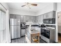 Functional kitchen with stainless steel appliances, ample cabinets, and movable island at 5245 Chemin De Vie, Atlanta, GA 30342