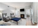 Living room with fireplace, stylish seating, and French doors to another room at 5245 Chemin De Vie, Atlanta, GA 30342