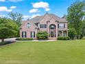 Traditional brick home with manicured lawn, mature trees, and classic design at 7493 Elderberry Dr, Douglasville, GA 30135