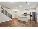 Open-concept living area featuring a modern kitchen with stainless steel appliances and a large island at 2111 Wesson Ct, Kennesaw, GA 30144