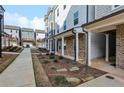 A paved walkway leads to townhomes with maintained landscaping in a Gathering-friendly neighborhood at 2111 Wesson Ct, Kennesaw, GA 30144