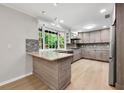 Modern kitchen with stainless steel appliances, a breakfast bar and outdoor views at 2828 Cloverhurst Dr, Atlanta, GA 30344