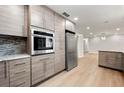 Kitchen with stainless steel appliances and wood-look cabinets with a connecting room at 2828 Cloverhurst Dr, Atlanta, GA 30344