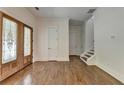 Inviting entryway with hardwood floors, decorative glass door, and access to the upper level at 3599 Centerville Rosebud Rd, Snellville, GA 30039