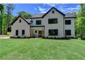 Charming two-story home boasts a brick facade, black accents, and a well-manicured lawn at 3599 Centerville Rosebud Rd, Snellville, GA 30039
