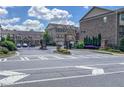 Gated community entrance with brick pillars, mature landscaping, and a secure entry system at 4206 Townsend Ln, Atlanta, GA 30346