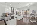 Modern, bright kitchen with stainless steel appliances, black countertops, a large island, and an adjacent breakfast nook area at 4206 Townsend Ln, Atlanta, GA 30346