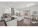 Modern kitchen with white cabinetry, granite countertops, stainless steel appliances, and an island with bar seating at 4206 Townsend Ln, Atlanta, GA 30346
