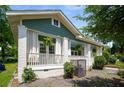 Inviting craftsman-style home with a covered porch, white brick pillars, and hanging ferns for added charm at 1545 Montreat Sw Pl, Atlanta, GA 30311