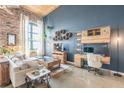 Spacious living room with a comfortable sofa, modern furniture, and exposed brick wall at 170 Boulevard Se # 521H, Atlanta, GA 30312