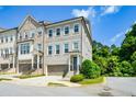 Beautiful townhome with a gray painted brick facade, two-car garage and charming architectural details at 2187 Elmont Se Way, Smyrna, GA 30080