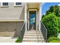 Close-up of the front door entrance of the home, featuring stone steps and a modern steel handrail at 2187 Elmont Se Way, Smyrna, GA 30080
