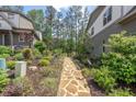 Tranquil backyard stone pathway amidst lush greenery and manicured garden beds at 232 Heron Pointe Vw, Canton, GA 30114