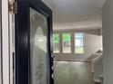 A view of the living room through the front door, with wood floors and natural light at 486 Victoria Rd, Woodstock, GA 30189