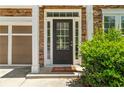 Close-up of the front door, complemented by stone accents and manicured greenery at 1125 Harvest Brook Way, Lawrenceville, GA 30043