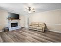 Spacious living room with a brick fireplace, modern flooring, and a cozy atmosphere at 1493 Martin Nash Sw Rd, Lilburn, GA 30047