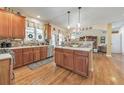 Charming kitchen with stainless steel appliances, wood cabinets, an island, and hardwood floors at 1730 Millhouse Run, Marietta, GA 30066