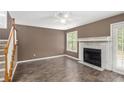 Open-concept living room with a fireplace and a ceiling fan at 175 Fenwyck Commons, Fayetteville, GA 30214