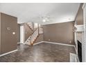 Spacious living room with dark wood floors, fireplace, and staircase at 175 Fenwyck Commons, Fayetteville, GA 30214