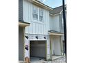 A modern, new construction townhouse showing the front exterior with covered garage at 29 Benscot Dr, Austell, GA 30106