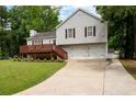 Two-story home with a deck, two-car garage, driveway and landscaped front lawn at 701 Rockingham Ct, Woodstock, GA 30189