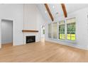 Open living space with large windows, fireplace and hardwood flooring that offers ample natural light at 210 Regester Way, Peachtree City, GA 30269