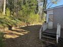 Backyard with partial fence, wooden steps and condition needing repair at 2284 Beecher Sw Cir, Atlanta, GA 30311