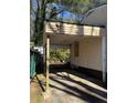 Side view of the home shows covered carport and condition of exterior needing repair at 2284 Beecher Sw Cir, Atlanta, GA 30311