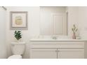 Bright bathroom featuring white vanity, neutral artwork, and modern decor, offering a clean aesthetic at 2489 Cotton Ln, Douglasville, GA 30135