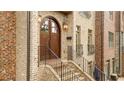 A stunning brick entrance featuring a grand arched wooden door and elegant outdoor lighting at 538 Micayne Cir # 3, Smyrna, GA 30082