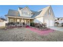 Inviting two-story home with a charming front porch and a two car garage at 7492 Ferrara Dr, Lithonia, GA 30058