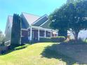 Brick home with front porch and nicely manicured lawn and landscaping at 140 Puckett Creek Dr, Canton, GA 30114