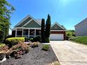Front exterior view of a brick home with two car garage and mature landscaping at 140 Puckett Creek Dr, Canton, GA 30114