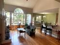 Spacious living room with hardwood floors, large windows, and high ceilings, perfect for entertaining guests at 140 Puckett Creek Dr, Canton, GA 30114