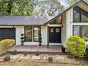 Inviting front entryway with a charming porch, decorative plants, and a well-maintained lawn at 1759 Kimberly Sw Dr, Marietta, GA 30008