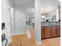 View of the foyer featuring hardwood floors and an open concept layout to the kitchen and living area at 1975 Nocturne Dr # 2303, Alpharetta, GA 30009